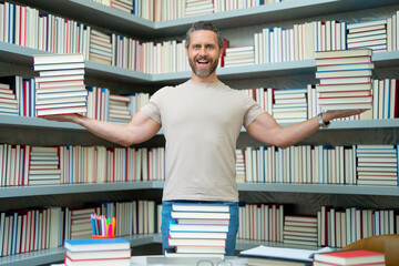Funny teacher hold many books. Crazy teacher with books. Excited teacher in school book library. University exam. Study teach in college. Educator learning courses. Studying literature. Teachers day.
