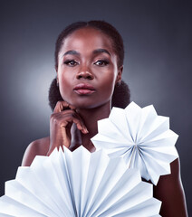 Black woman, portrait and origami fans for beauty, cosmetics and oriental on studio background....