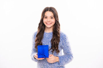 Teen with gift, celebrating teenagers birthday. Christmas teenager girl with gift, x-mas, happiness concept. Happy girl in winter sweater holding gift box. Isolated stodio background.