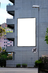 White billboard vertically on a residential building in Chiasso