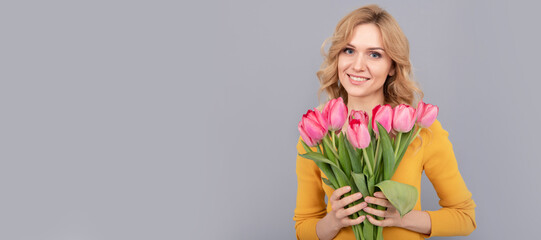 Girl with spring tulips flowers. lady hold flowers for spring holiday. girl with bouquet. Woman isolated face portrait, banner with mock up copy space.