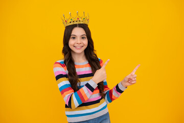 Teen child in queen crown isolated on yellow background. Princess girl in tiara. Teenage girl wear...