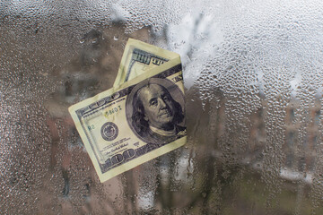 dollar bill concept. on wet glass. 