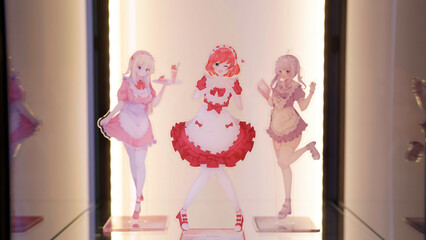 Three cute anime maid figures collection inside glass cabinet with LED lights