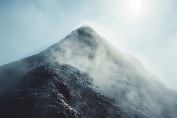 pointy mountain top with heavy smoke and fog near the top and clear weather at the foot in a mystic clean style with a tiny sunbeam shining into it from above