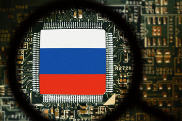 Flag of Russia on a processor. Computer board with chip. View through magnifying glass