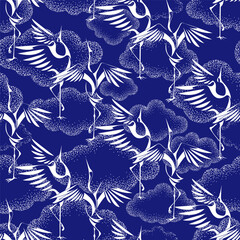 Fototapeta premium white silhouettes of cranes on the background of unusual clouds drawing in the dot technique. Seamless pattern, repeating background in two colors - blue and white