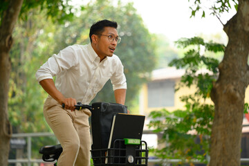 Active businessman commuting riding bicycle go to work during the morning rush