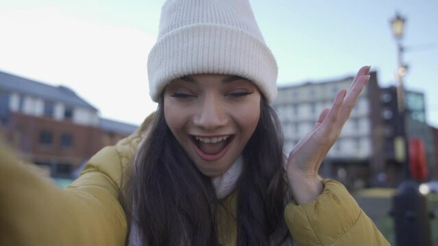 surprised woman talking on phone, covering mouth with hand from news