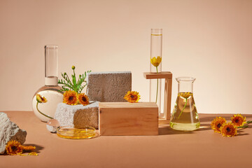 Front view of a wooden podium arranged with some rocks and laboratory glassware. Brown surface. Calendula has been used to treat a variety of skin conditions