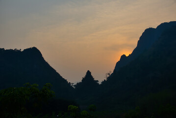 Golden light on the peaks: sunset in Vang Vieng