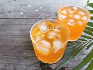 Orange soft drink and ice cubes