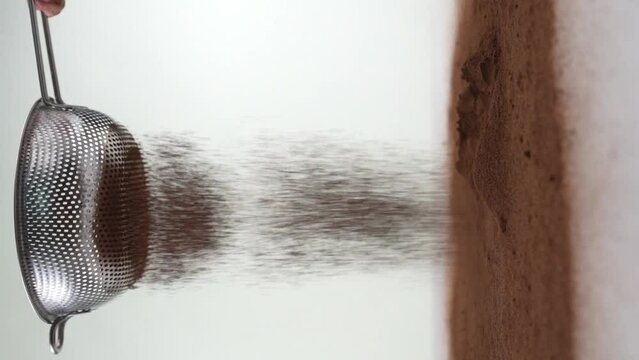 Brown powder falling from the top against white background