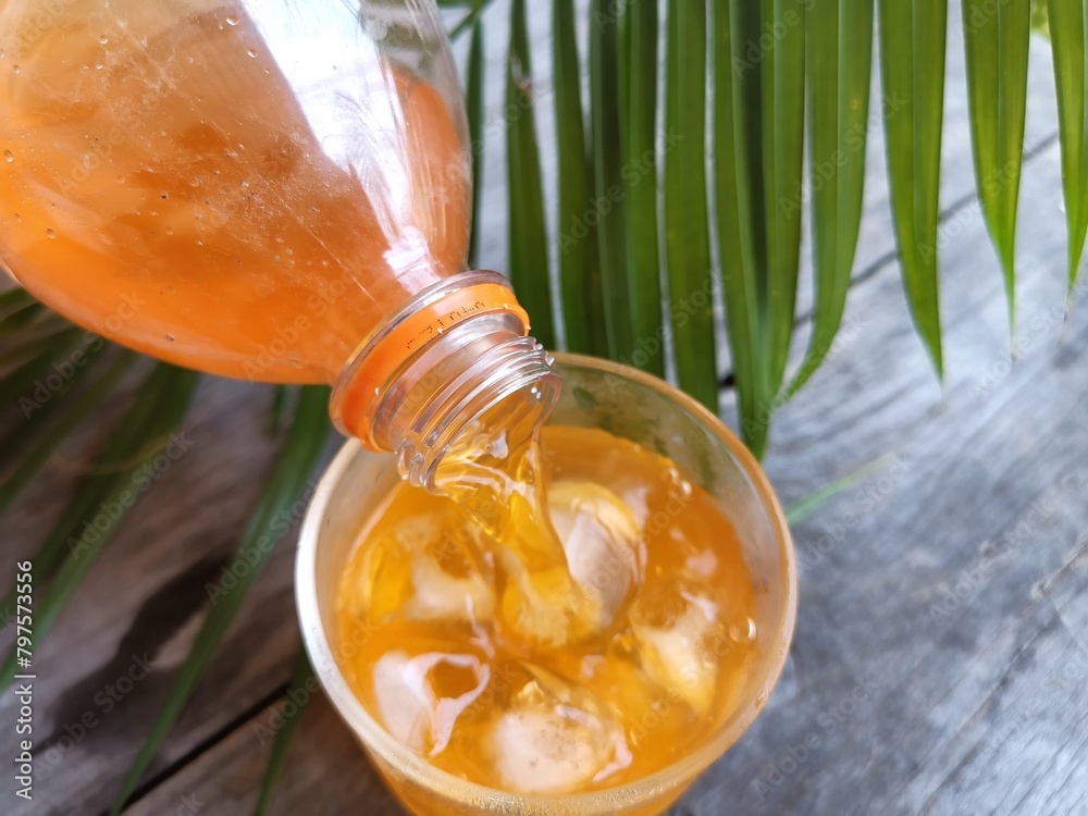 Wall mural orange soft drink and ice cubes