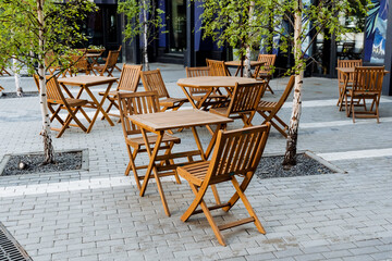 Outdoor wooden furniture set for leisure on sidewalk