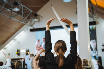 A leisure event with people raising arms in fun gesture