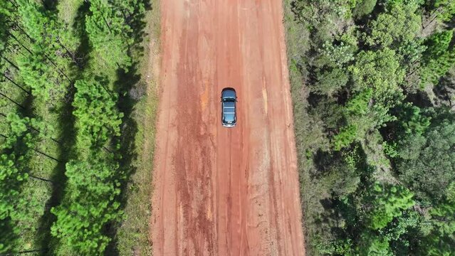 4K, drone 4WD car on red dirt road, rough potholes puddles, wet off road adventure, exploration family holiday vacation weekend