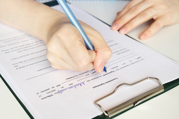 Commission agreement, hand fills out a document, business transaction, financial services, legal paperwork