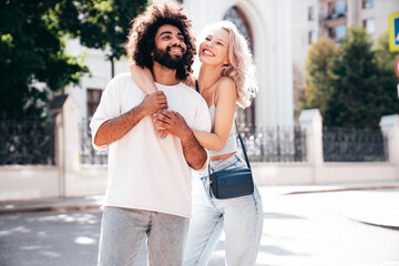 Smiling beautiful woman and her handsome boyfriend. Woman in casual summer jeans clothes. Happy...