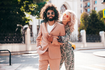 Beautiful fashion woman and her handsome elegant boyfriend in beige suit. Sexy blond model in...