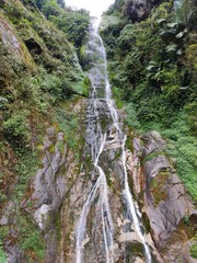 Nichiphula waterfall flow into the kameng river in a deep valley surrounded by mountains of the himalayas near Dedza, arunachal pradesh, India. 