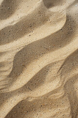 Obraz premium Sand textures with varying grain sizes and patterns, such as beach sand or desert sand. Sand textures can convey a serene and tranquil atmosphere. 