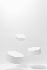 Abstract scene - three round white tilt podiums for cosmetic products mockup, fly in hard light,...