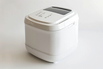 A compact bread maker featuring a white exterior and a removable non-stick bread pan isolated on a solid white background.