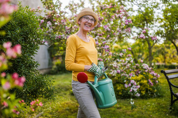 Portrait of happy senior woman gardening.	