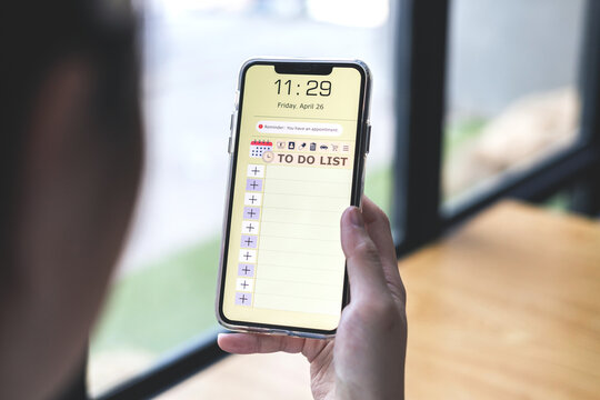 Reminder list concept. Woman uses smartphone application to record to-do list and reminders of important schedules, meeting appointments