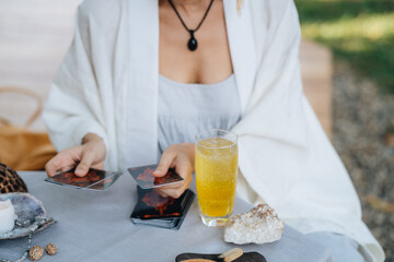 A woman is making tarot layout on the table