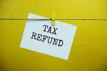 Tax Refund text on paper card hanging on the wall with Clothespins