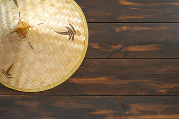 Chinese bamboo hat on dark wooden background with copy space.