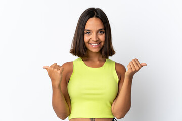 Young latin woman isolated on white background with thumbs up gesture and smiling