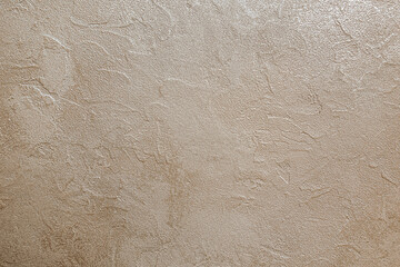 abstract background of white embossed plastered wall painted metallic beige close up