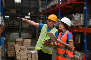 Two warehouse staff checking stock inventory production stock control, Warehouse control, and...