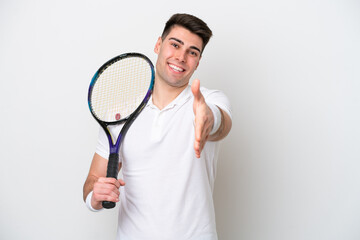 young tennis player man isolated on white background shaking hands for closing a good deal
