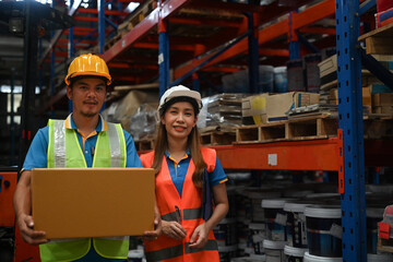 Two Warehouse workers portrait in a logistic warehouse, Distribution warehouse management concept