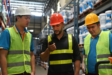 Warehouse manager and team using a walkie-talkie to communication for checking inventory
