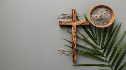Ash Wednesday arrangement of cross, ashes, and palm leaf on gray