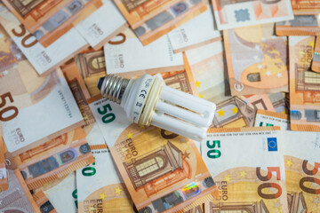 Light bulb with 50 euro note bills , Increase in electricity tariffs