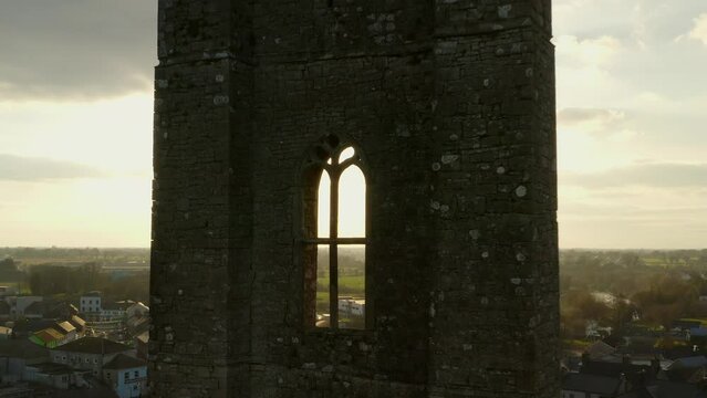 Picturesque view of an old irish abbey tower. Aerial pullback