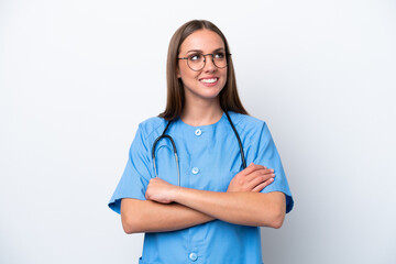Young nurse caucasian woman isolated on white background looking up while smiling