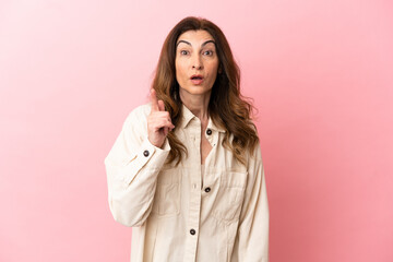 Middle aged caucasian woman isolated on pink background intending to realizes the solution while...