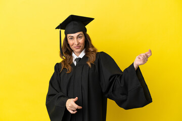 Middle aged university graduate isolated on yellow background making guitar gesture