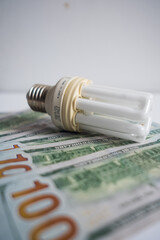 Light bulb with 100 usd note bills , Increase in electricity tariffs