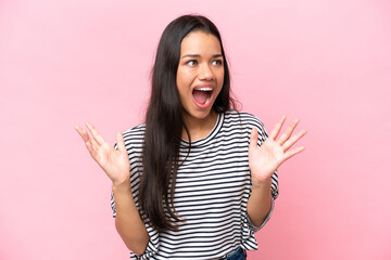 Young Colombian woman isolated on pink background with surprise facial expression