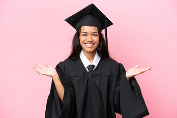 Young university Colombian woman graduate isolated on pink background with shocked facial expression