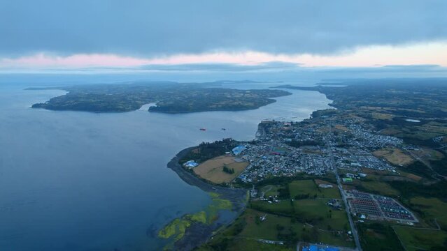 Aerial view of the Lemuy island with Chonchi in the background, during blue hour