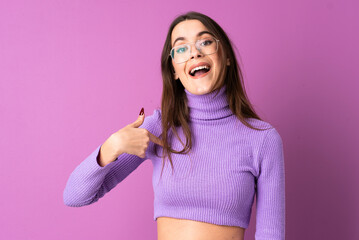 Young woman over isolated purple background with surprise facial expression